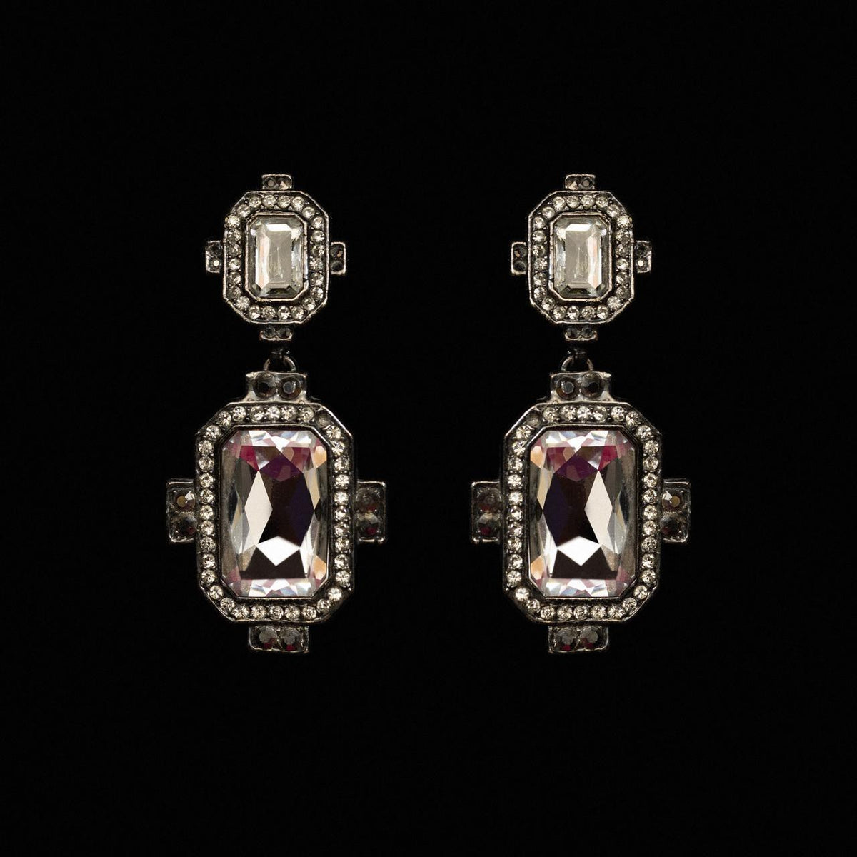 Art deco drop earrings with a large lilac emerald-cut crystal in a stepped pave frame