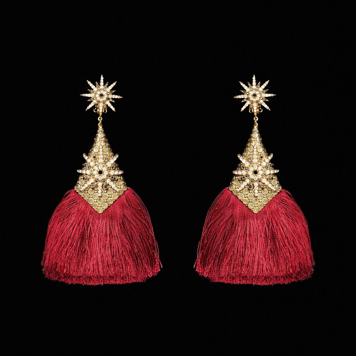 Gold-tone starburst earrings with long crimson silk tassels