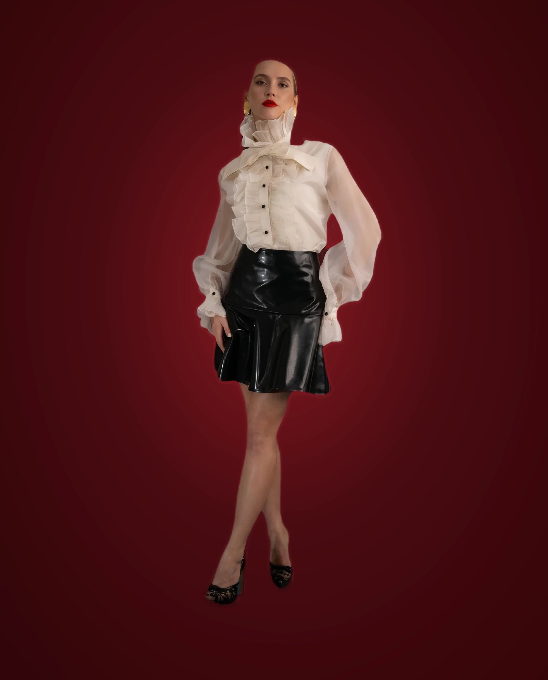 Ivory organza ruffled blouse with black patent flared mini skirt, full front view