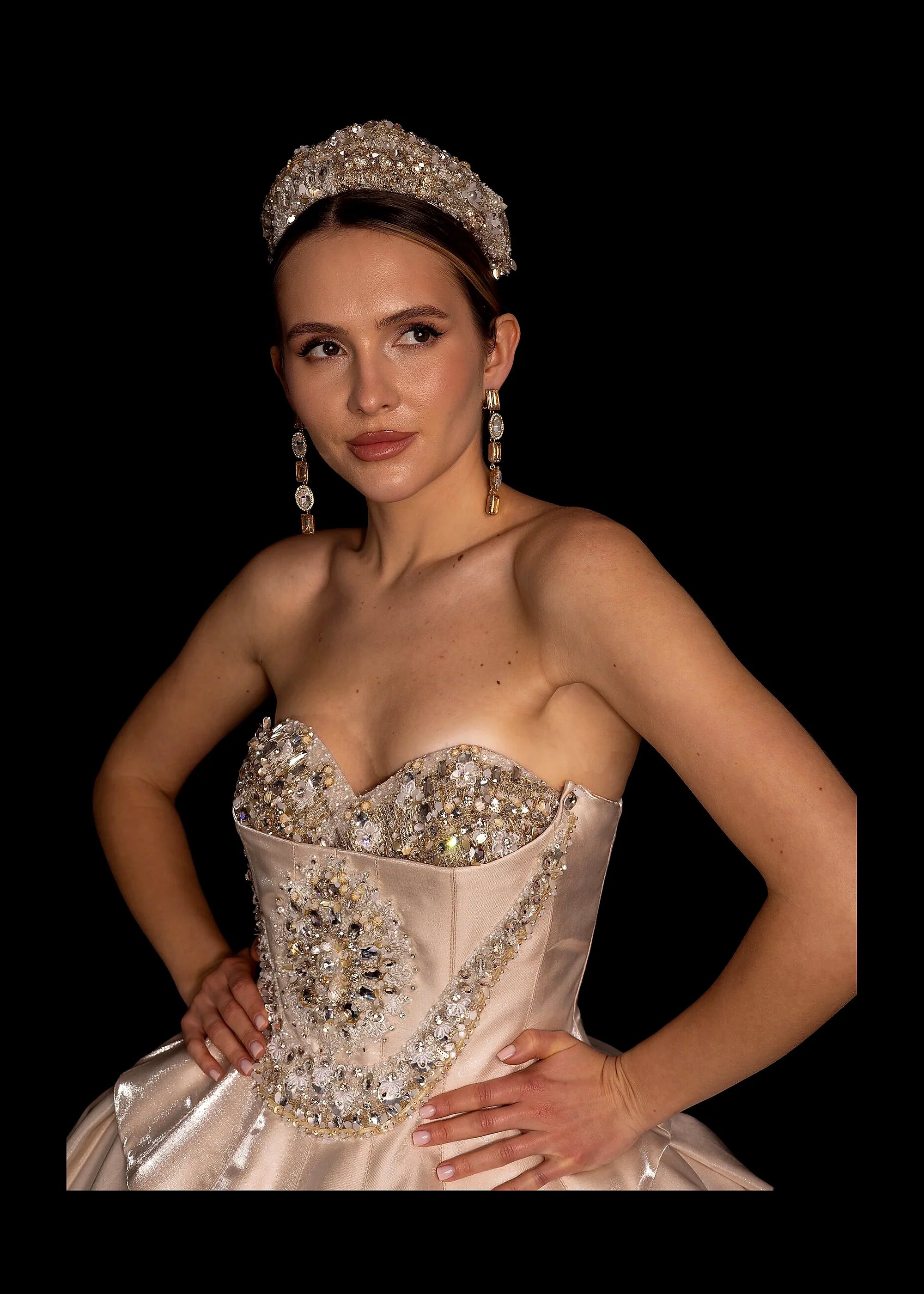Champagne satin ballgown with a beaded bodice, pearl crown and gold-lace veil.