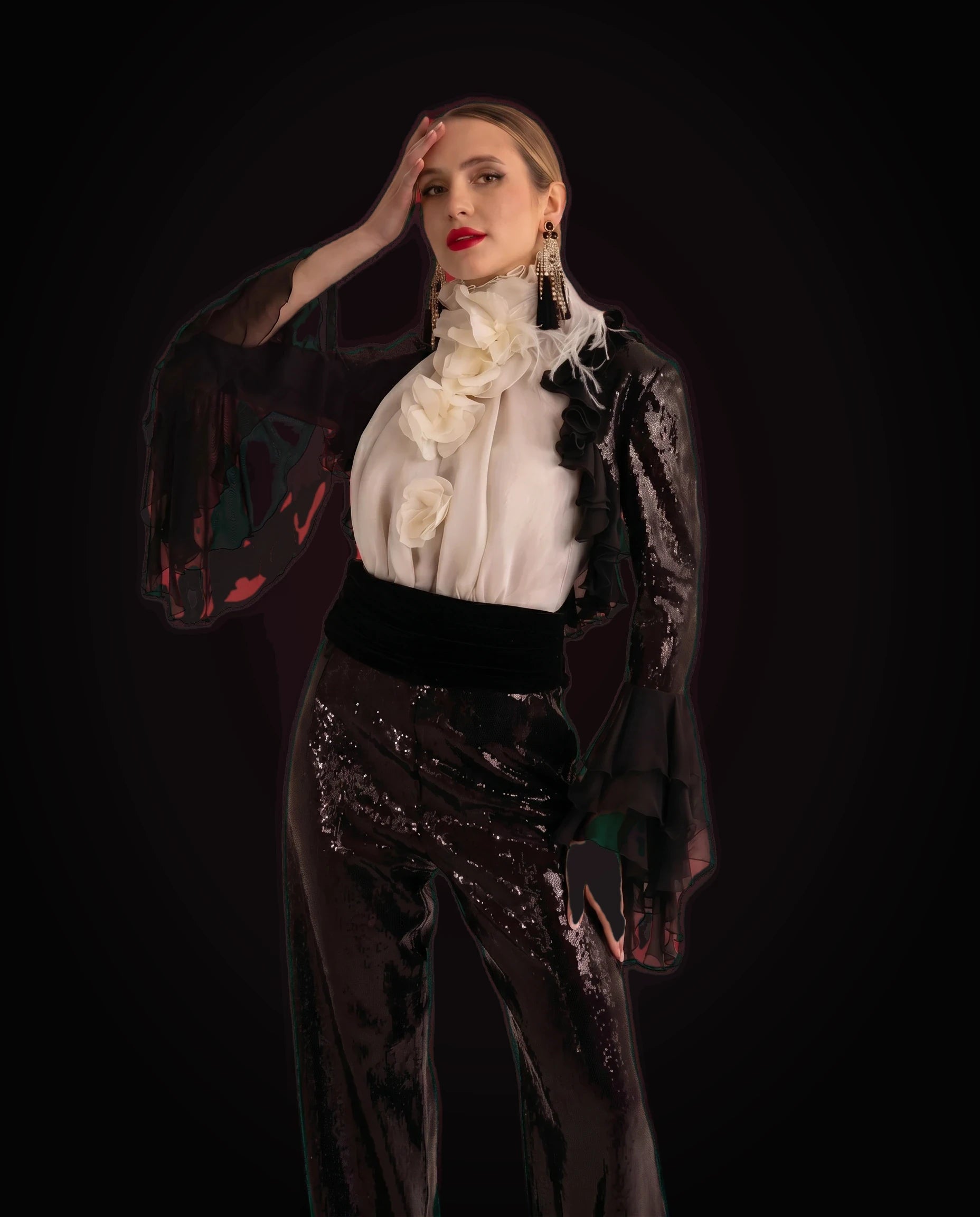 Black sequin trousers with ivory ruffled blouse and black chiffon bolero, three-quarter view