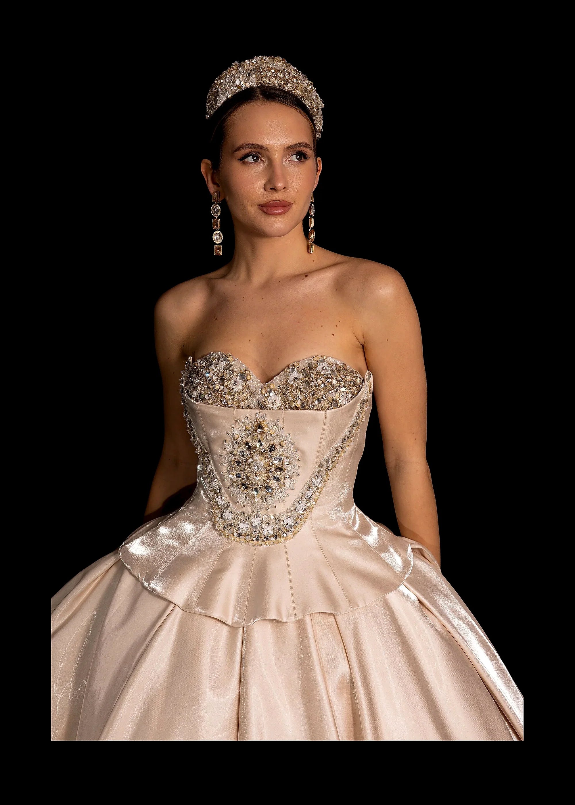 Champagne satin ballgown with a beaded bodice, pearl crown and gold-lace veil.