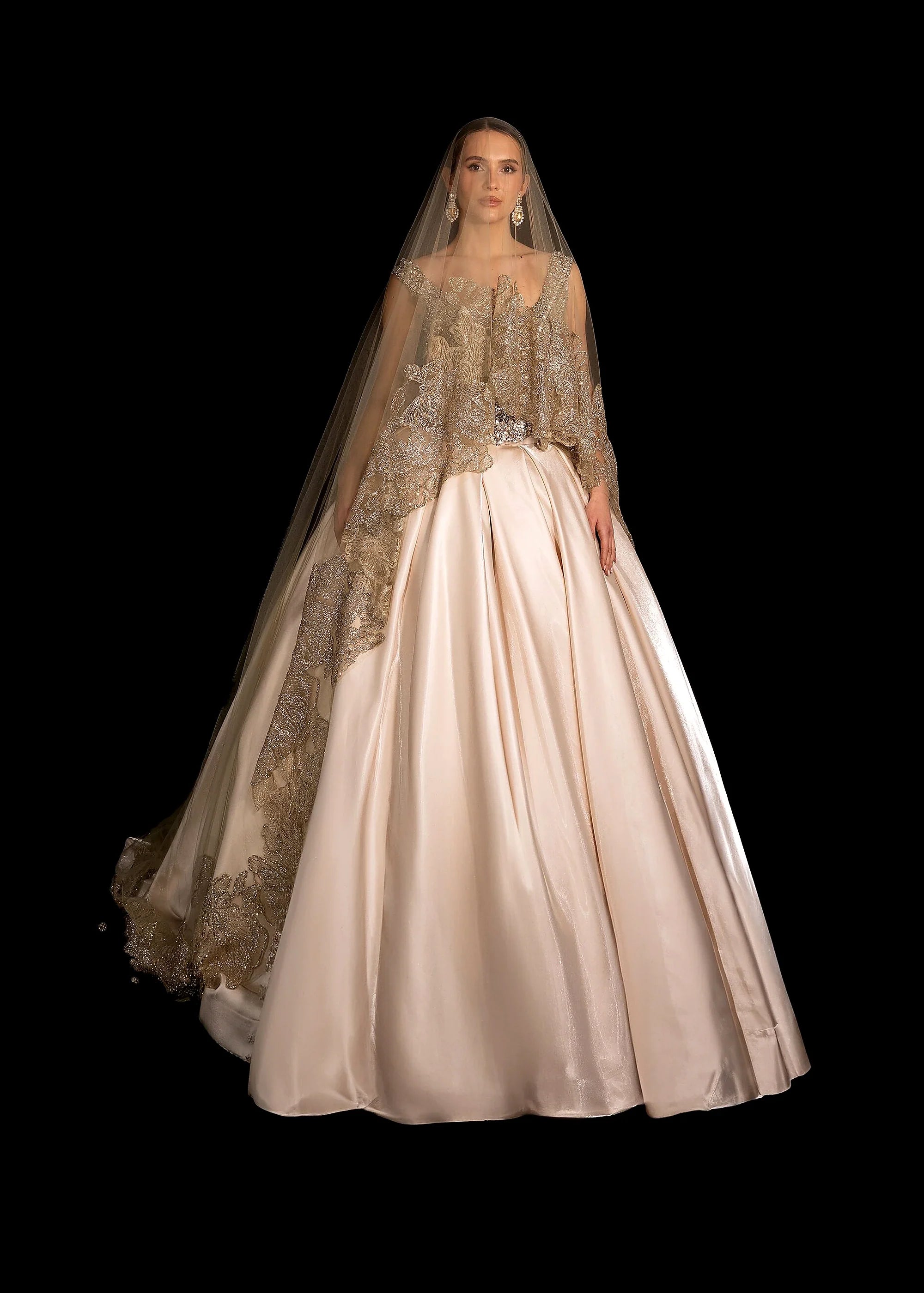 Champagne satin ballgown with a beaded bodice, pearl crown and gold-lace veil.