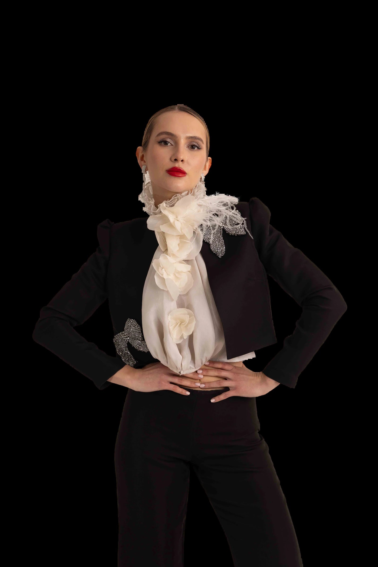 Black cropped jacket, ivory organza rosette blouse and flared black trousers, three-quarter view