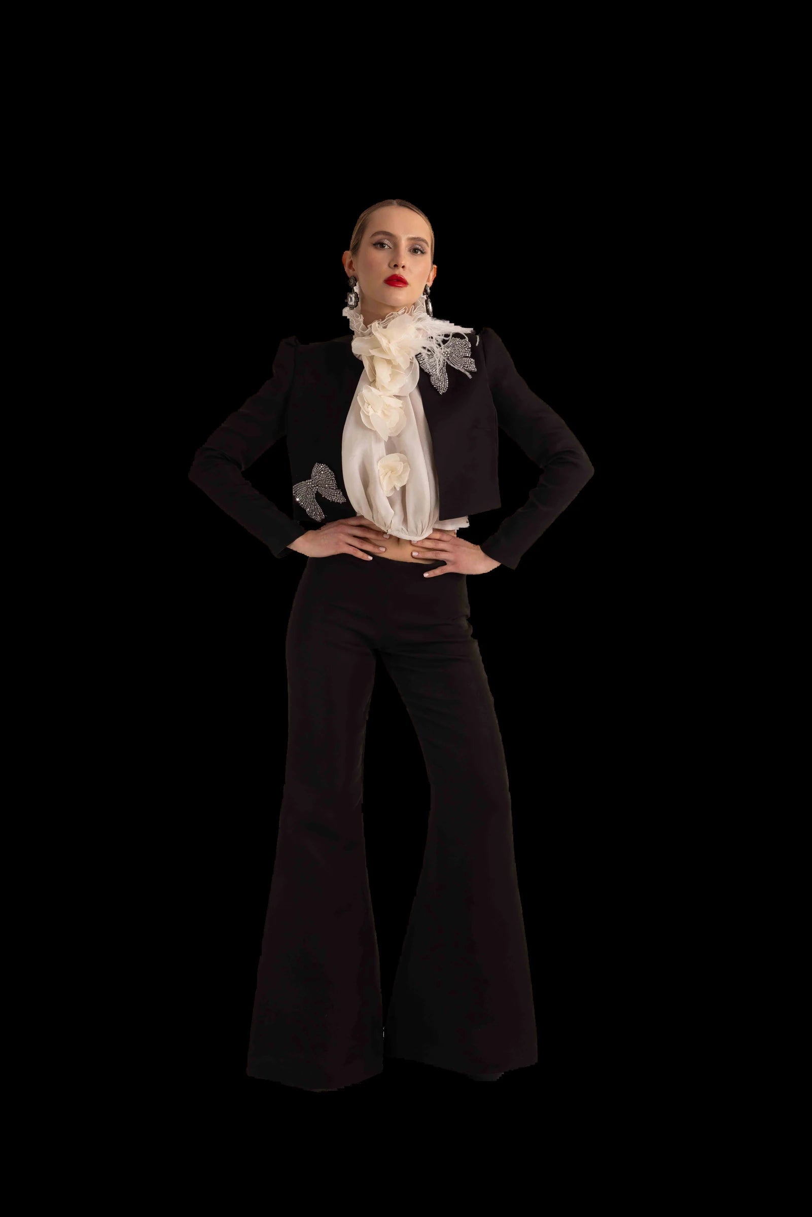 Black cropped jacket, ivory organza rosette blouse and flared black trousers, full front view