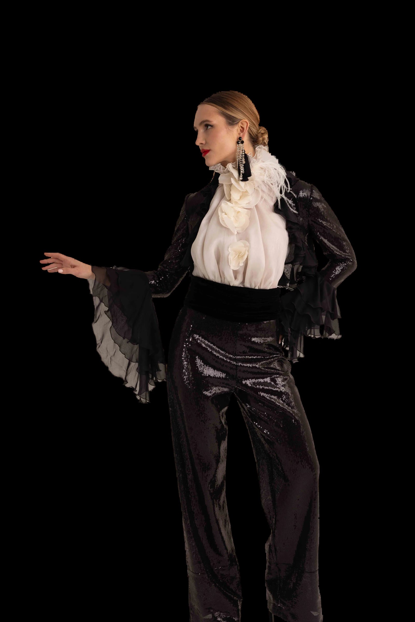 Black sequin trousers with ivory ruffled blouse and black chiffon bolero, three-quarter view