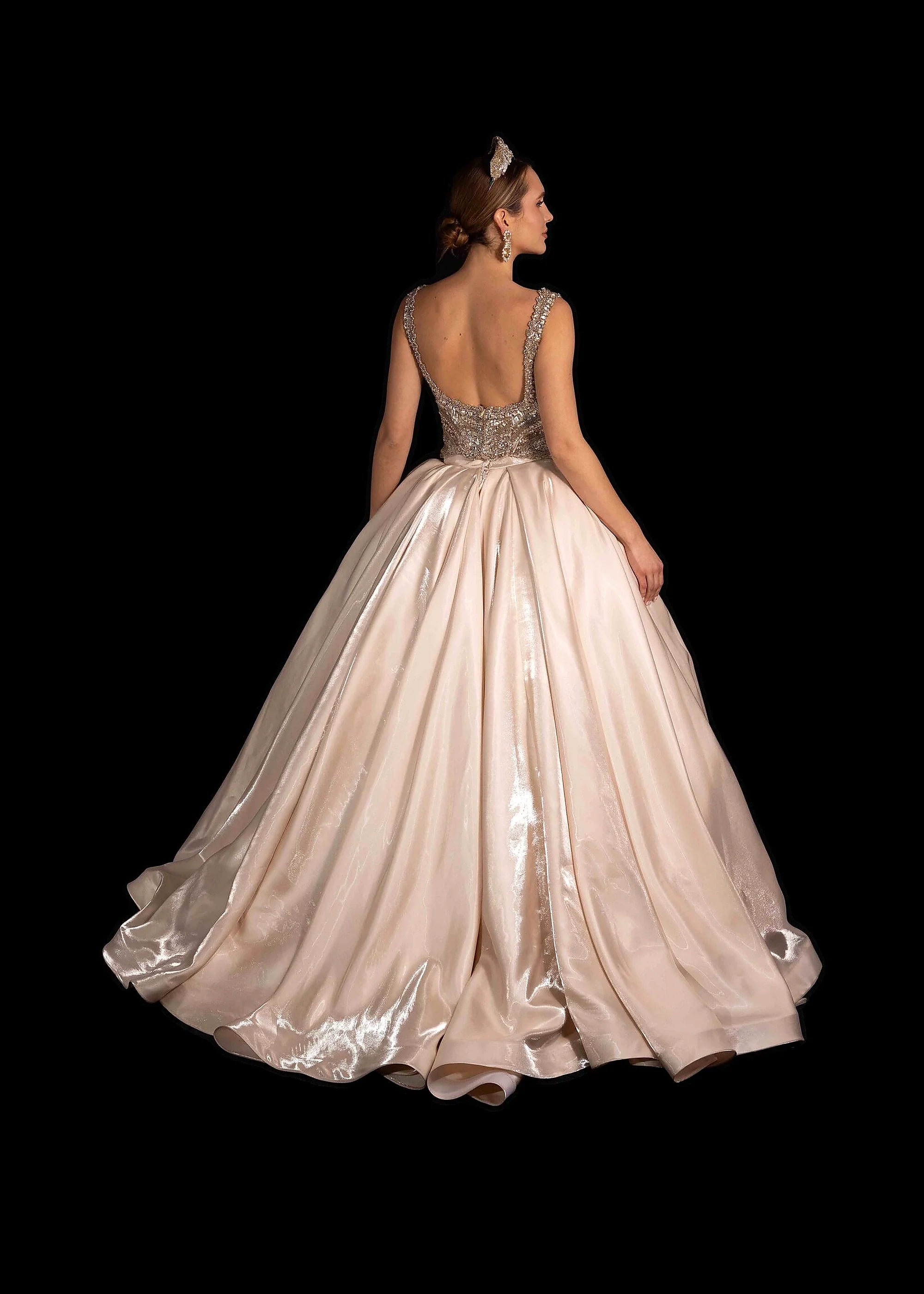 Champagne satin ballgown with a beaded bodice, pearl crown and gold-lace veil.