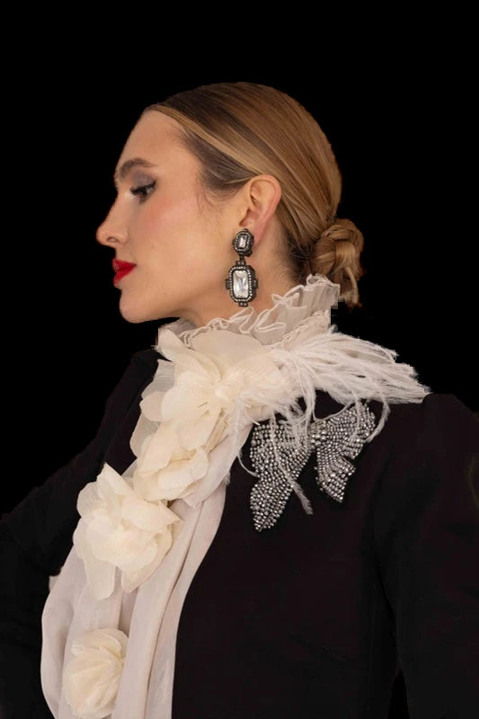 A black cropped jacket and flared trousers with a ruffled organza scarf.