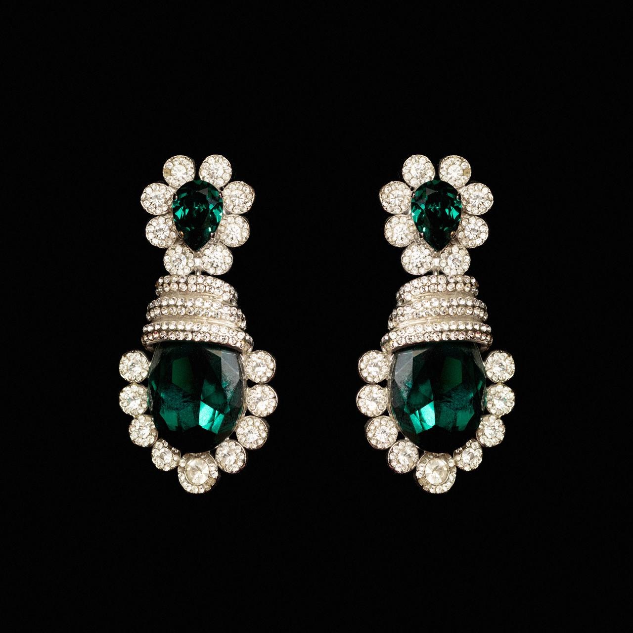 Statement drop earrings with deep green pear and oval crystals ringed in clear stones