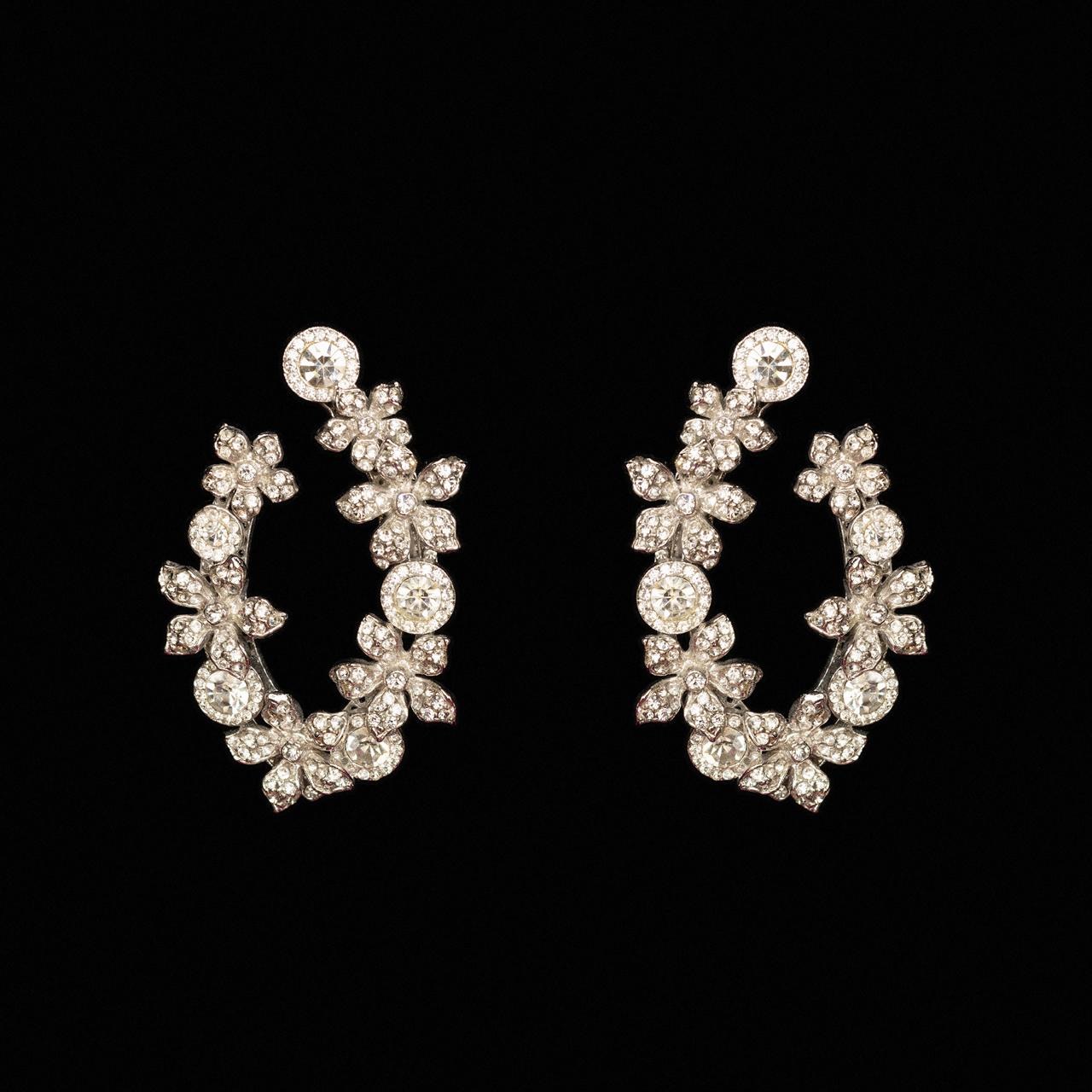 Open silver-tone crystal wreath earrings shaped in flowers and marquise leaves