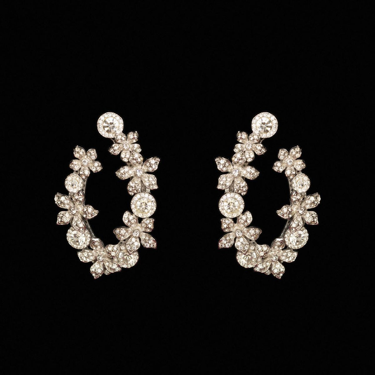 Open silver-tone crystal wreath earrings shaped in flowers and marquise leaves