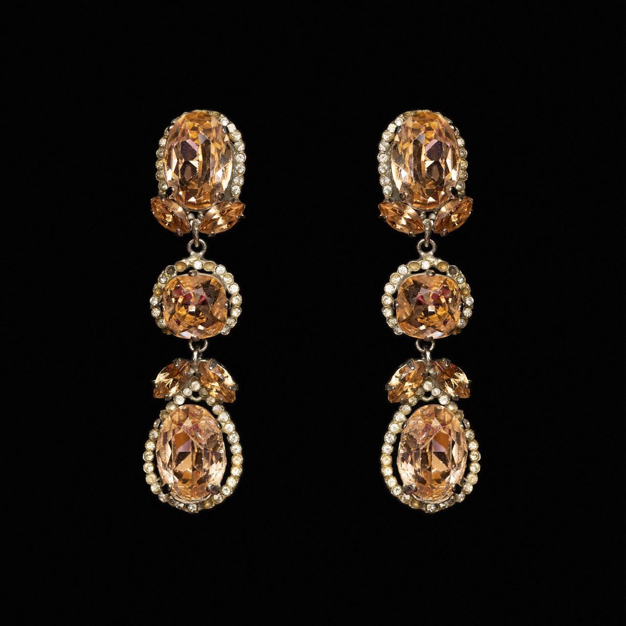 Three-tier drop earrings with apricot oval, cushion and pear-cut crystals in clear haloes