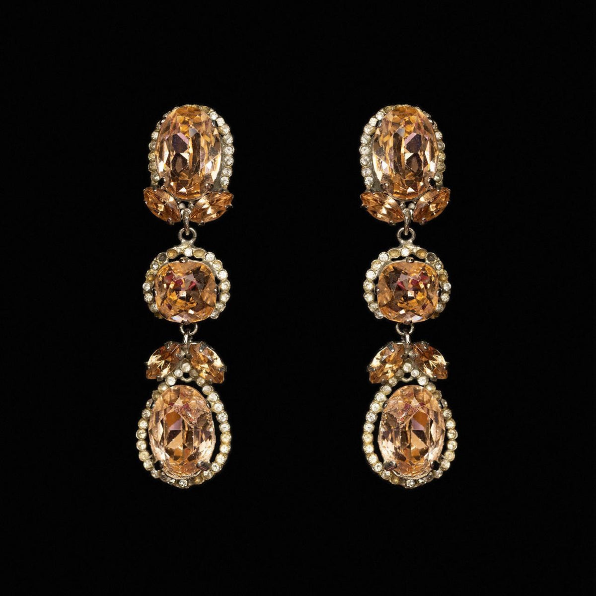 Three-tier drop earrings with apricot oval, cushion and pear-cut crystals in clear haloes
