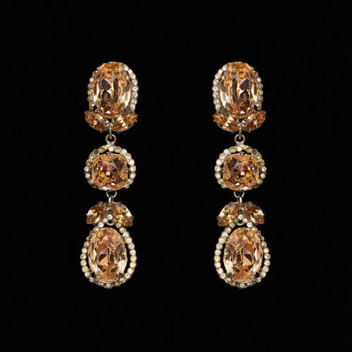 Three-tier drop earrings with apricot oval, cushion and pear-cut crystals in clear haloes
