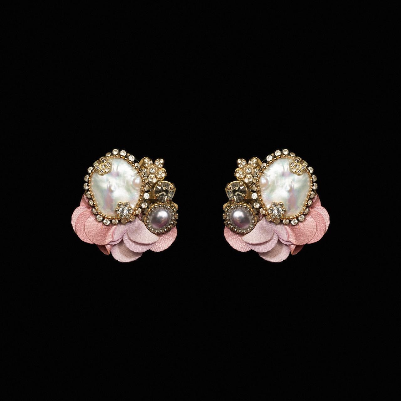 Clip earrings with a large baroque pearl and crystals set on blush pink petals