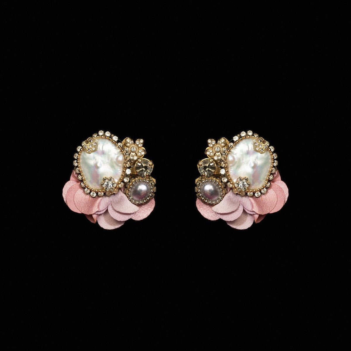Clip earrings with a large baroque pearl and crystals set on blush pink petals