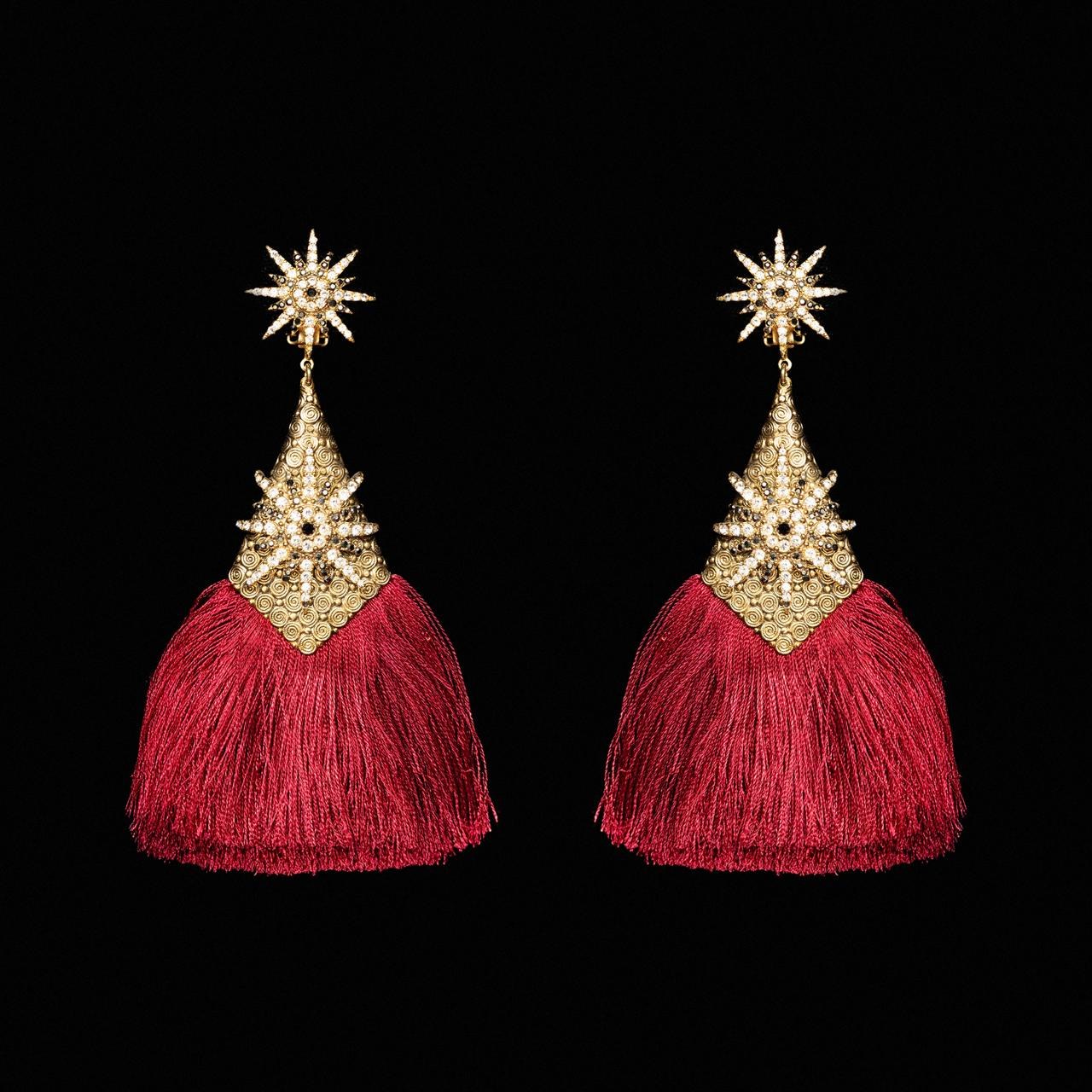 Gold-tone starburst earrings with long crimson silk tassels