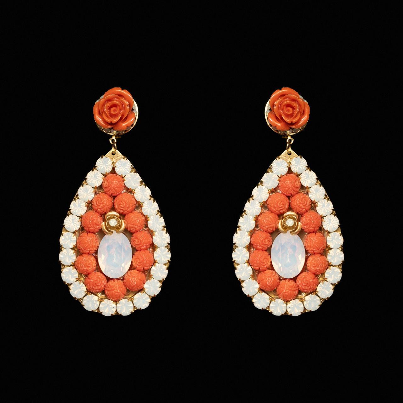 Teardrop earrings filled with carved coral-orange beads around a milky opaline centre