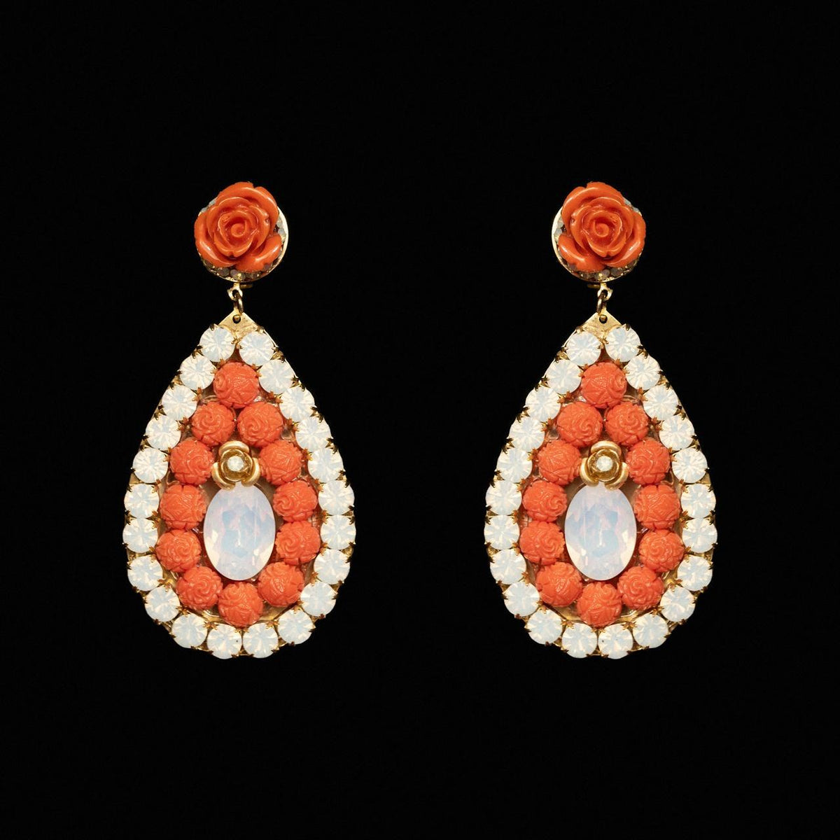 Teardrop earrings filled with carved coral-orange beads around a milky opaline centre