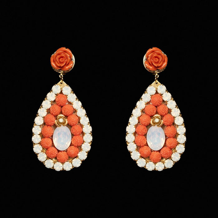 Teardrop earrings filled with carved coral-orange beads around a milky opaline centre