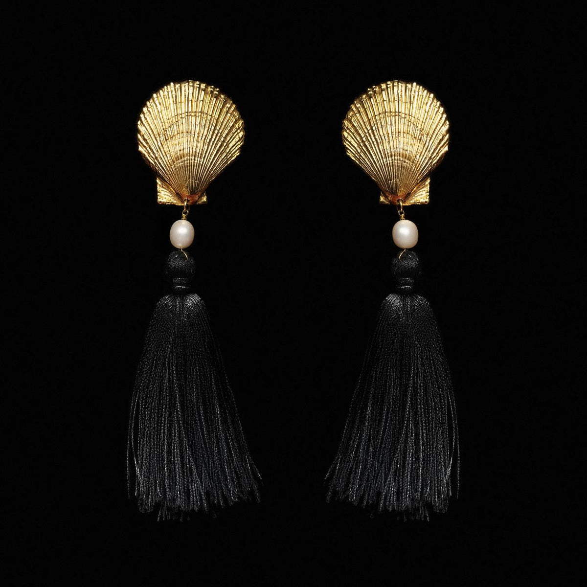 Gold-tone scallop shell earrings with a white pearl and long black silk tassels