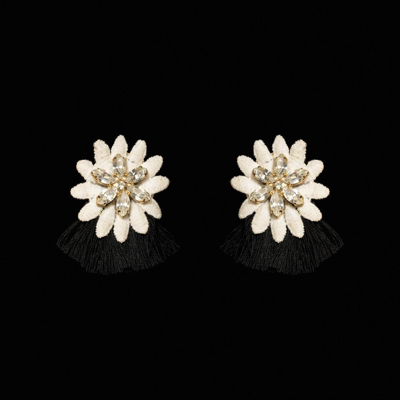 White carved petal flower earrings with a crystal centre and short black silk fringe