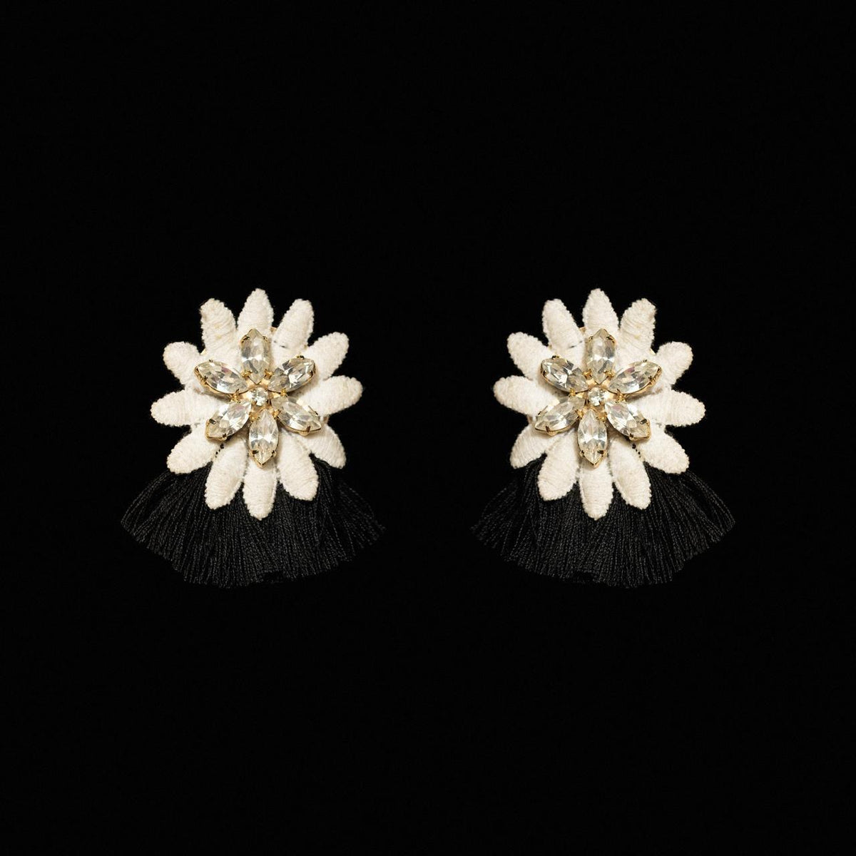 White carved petal flower earrings with a crystal centre and short black silk fringe