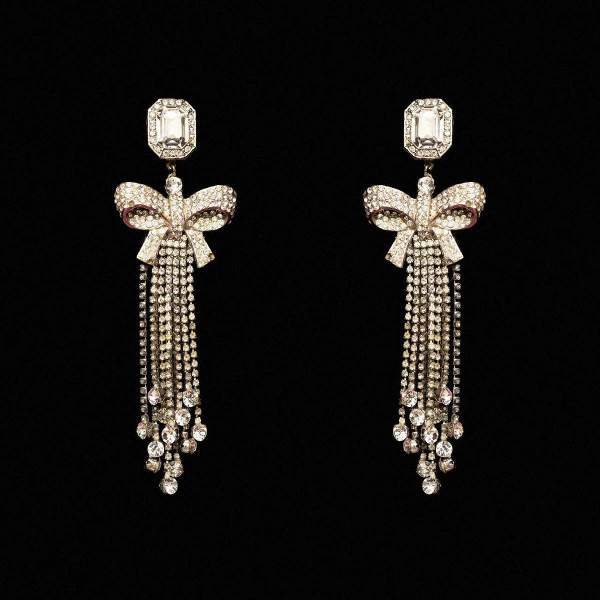 Silver-tone crystal bow earrings with long falling chains of clear crystal