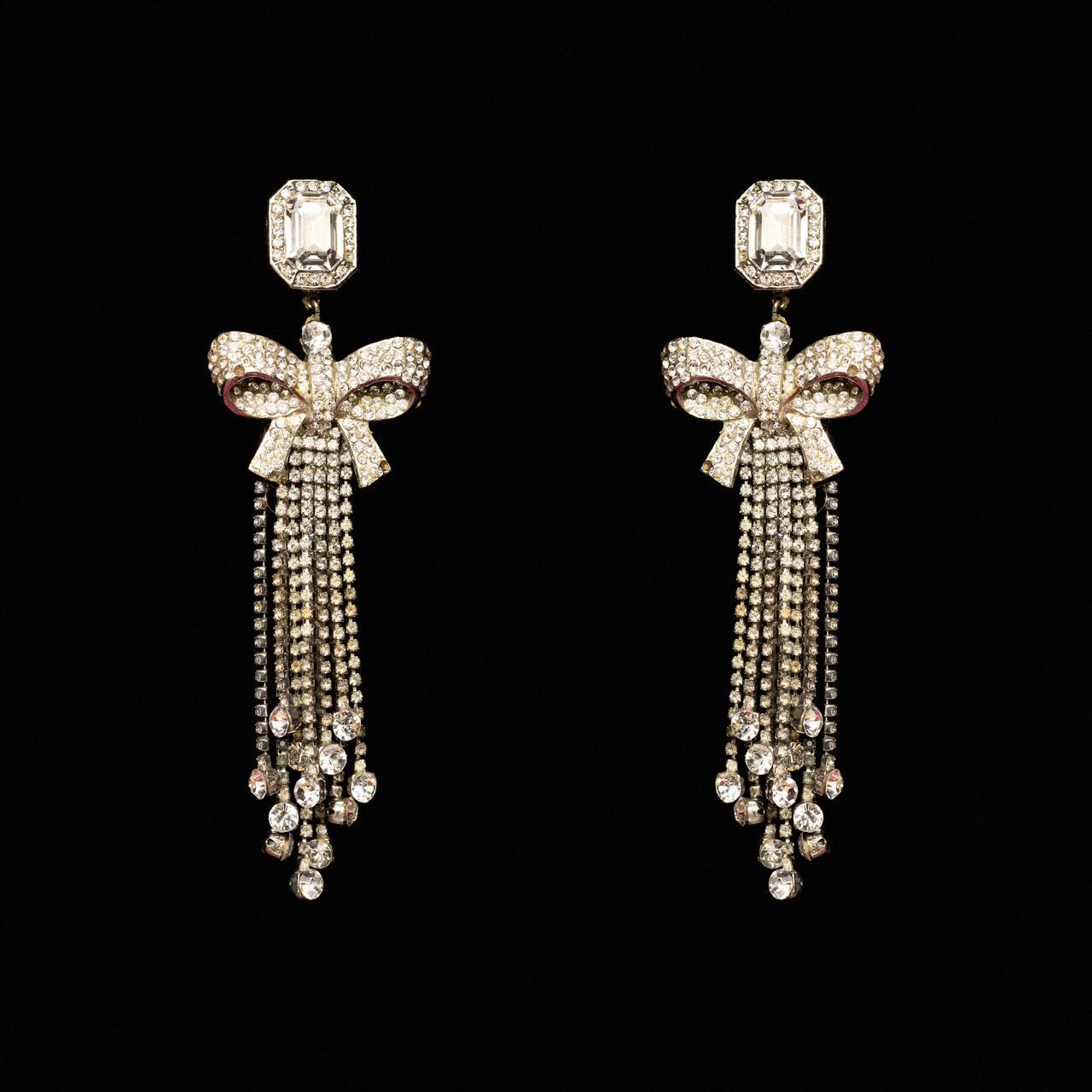Silver-tone crystal bow earrings with long falling chains of clear crystal