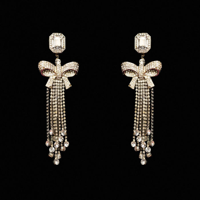 Silver-tone crystal bow earrings with long falling chains of clear crystal