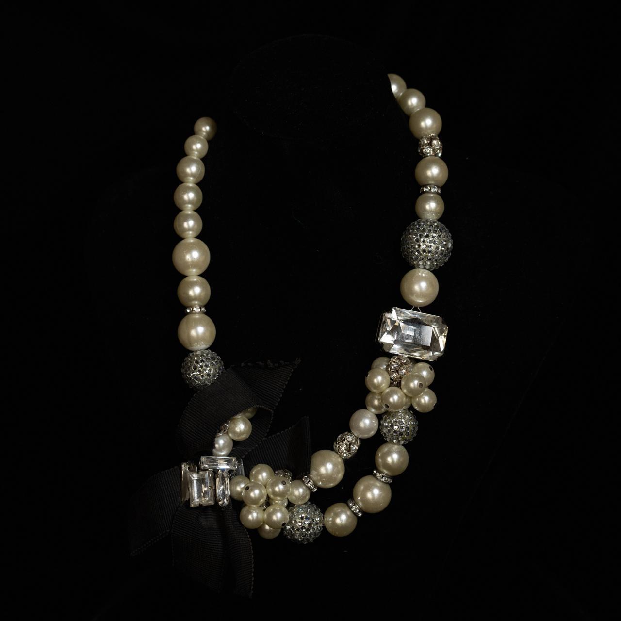 Graduated pearl necklace with crystal rondelles and a black grosgrain ribbon tie