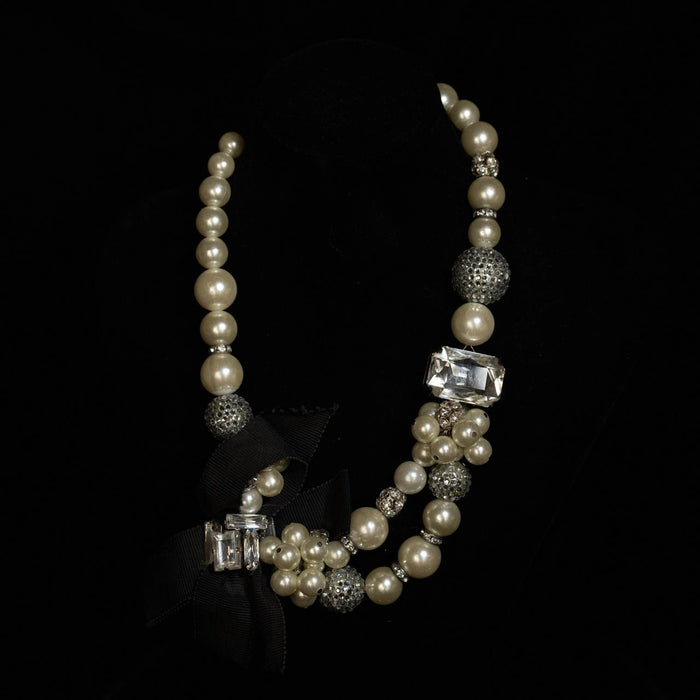 Graduated pearl necklace with crystal rondelles and a black grosgrain ribbon tie