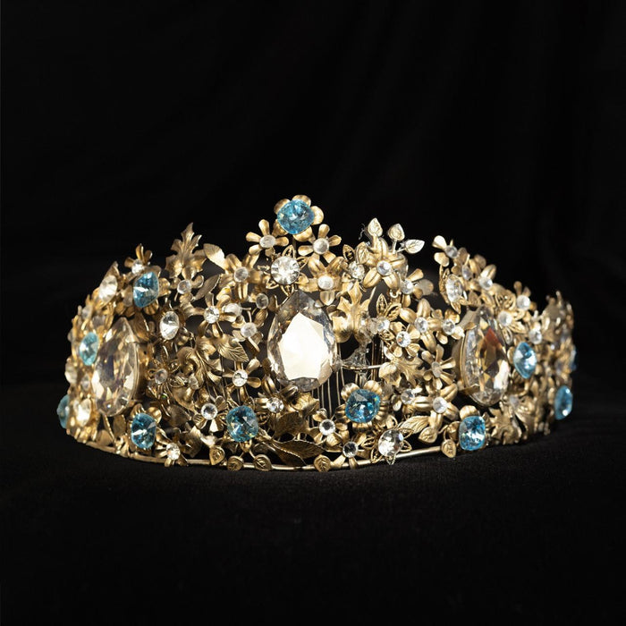 Wide gold-tone floral bridal crown set with pale blue and clear crystals