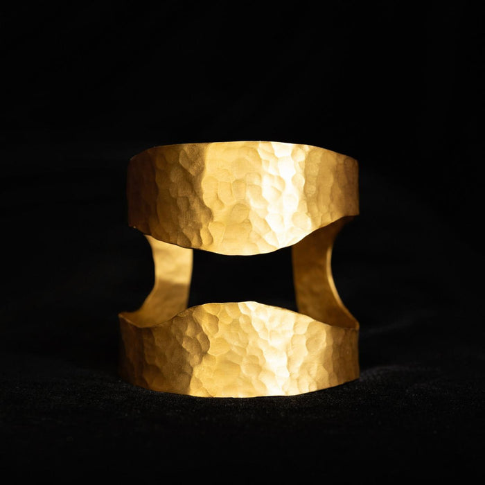 Wide hammered gold-tone cuff bracelet with an open cut-away centre