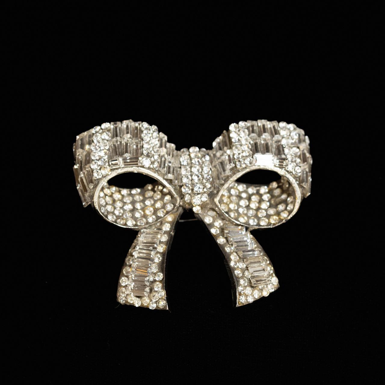 Clear crystal ribbon bow brooch in baguette and round pave with open loops