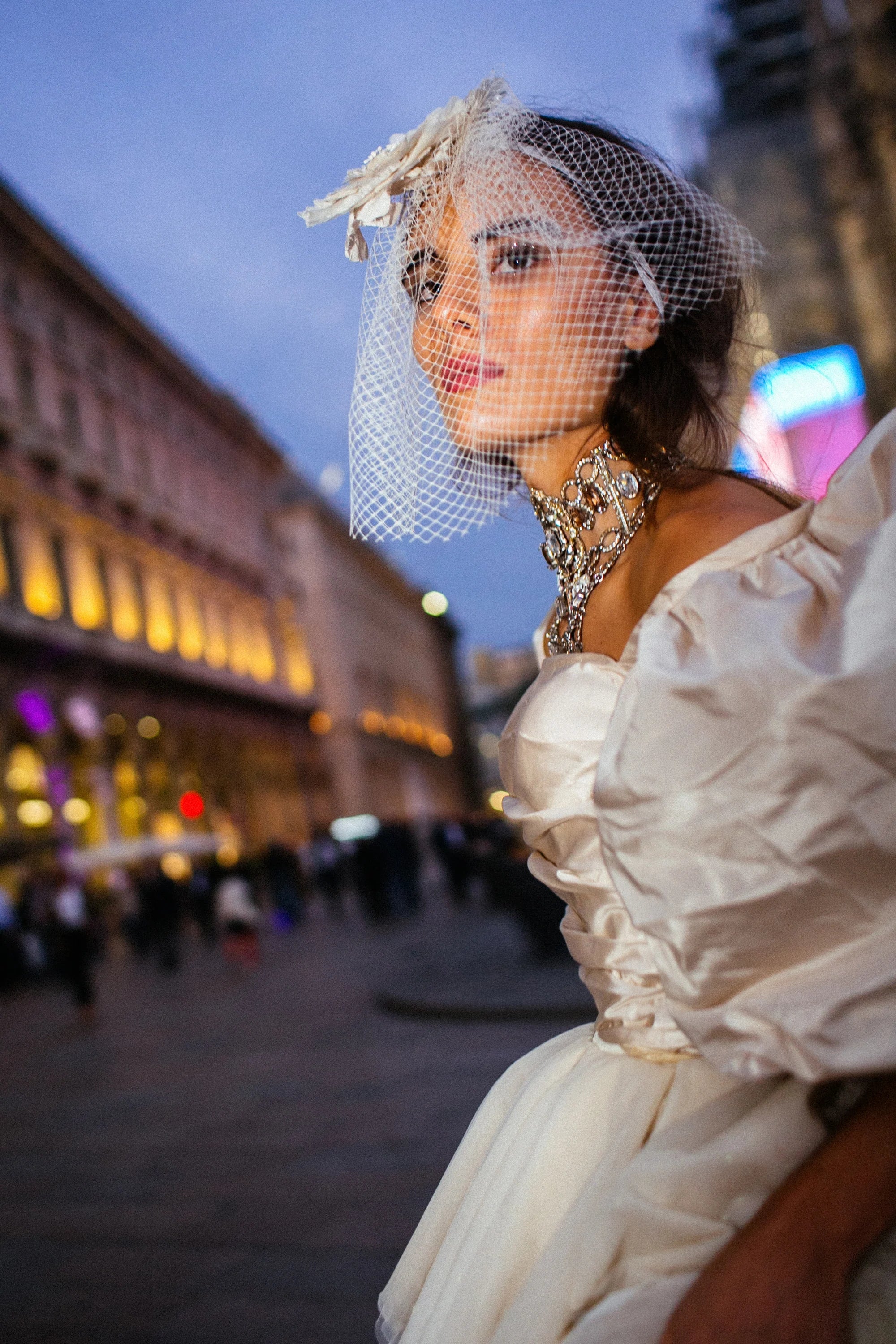 An ivory tulle ballgown with full puff sleeves, photographed in the piazza before the Duomo, Milan.