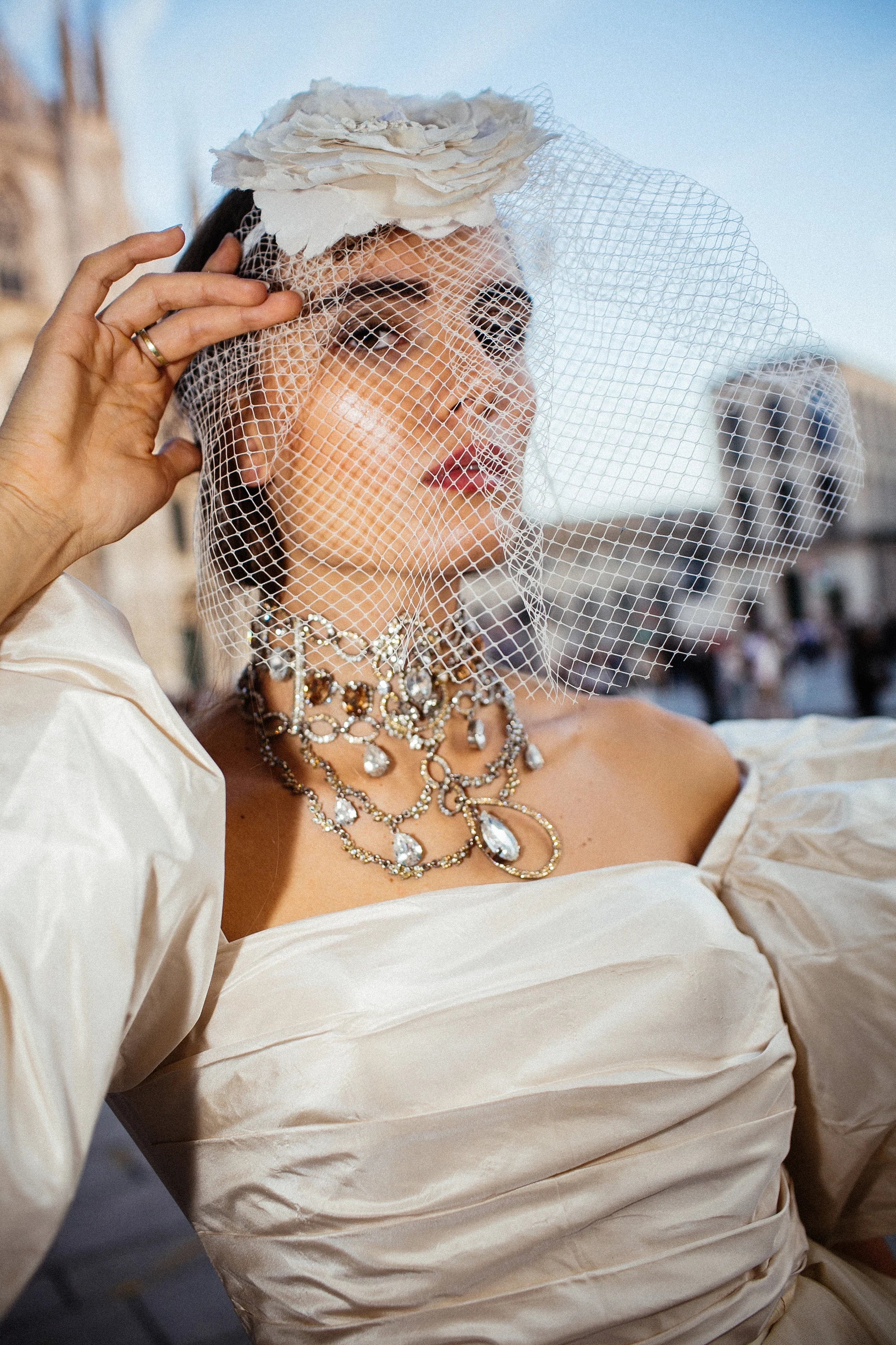 An ivory tulle ballgown with full puff sleeves, photographed in the piazza before the Duomo, Milan.