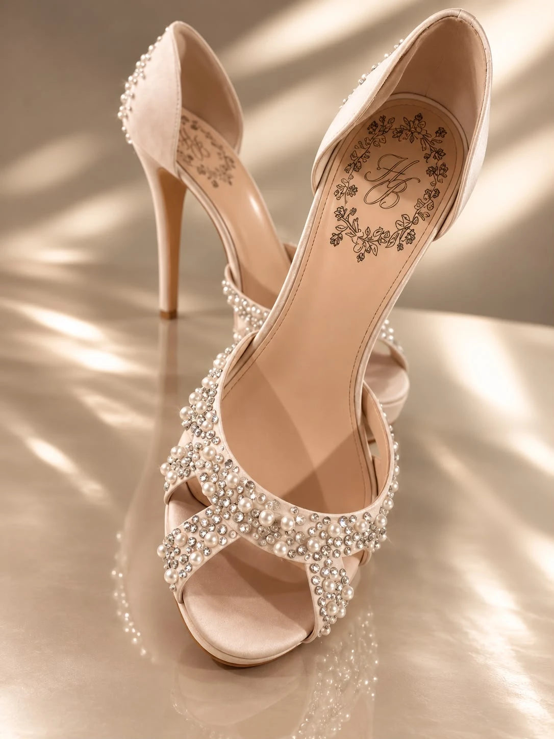 Pearl Crystal Peep-Toe by Maison Hanan, a blush satin peep-toe with crossed straps covered in pearls and crystals, photographed on a cream ground in raking light.