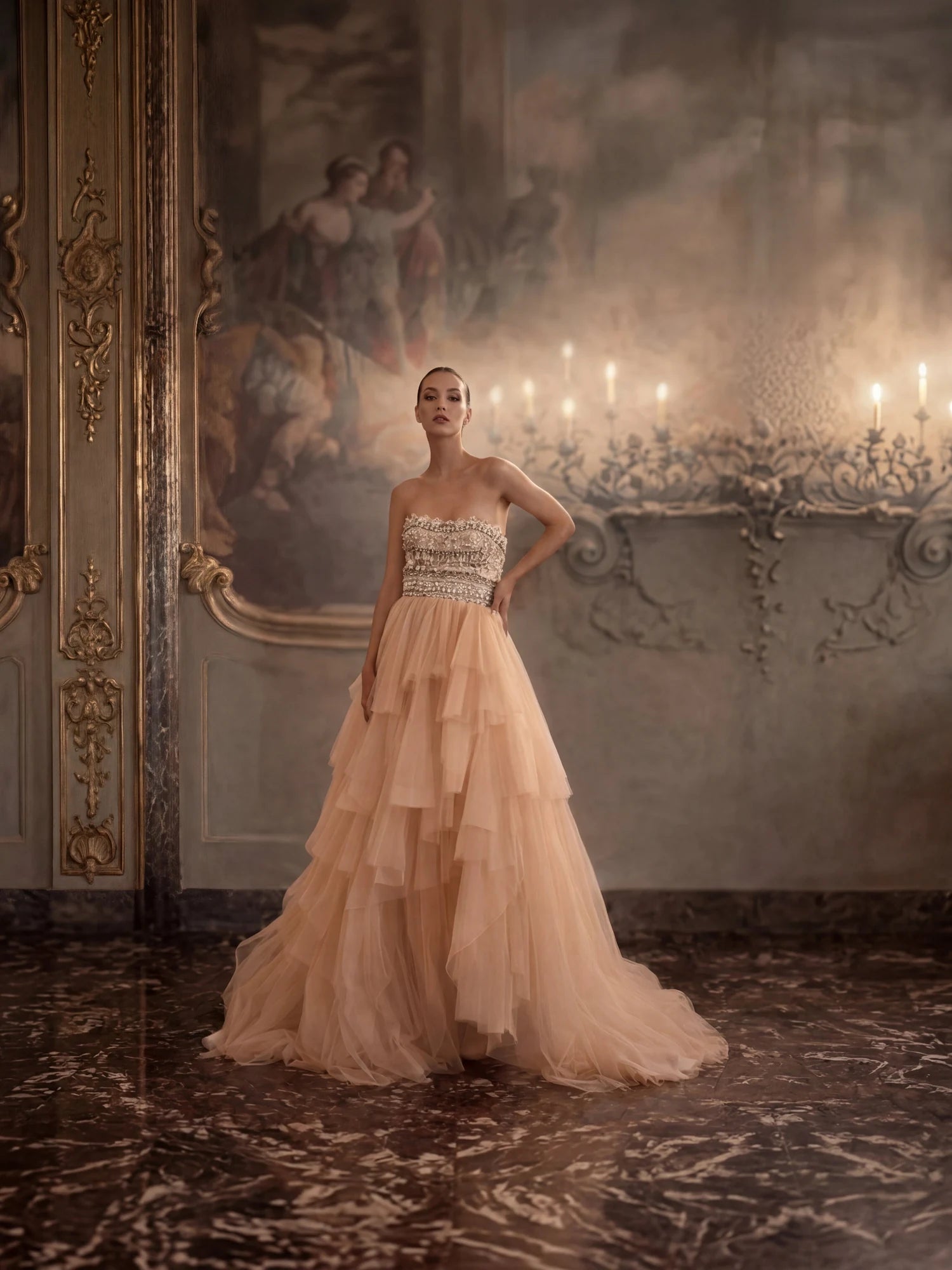 A blush gown photographed in a panelled doorway.
