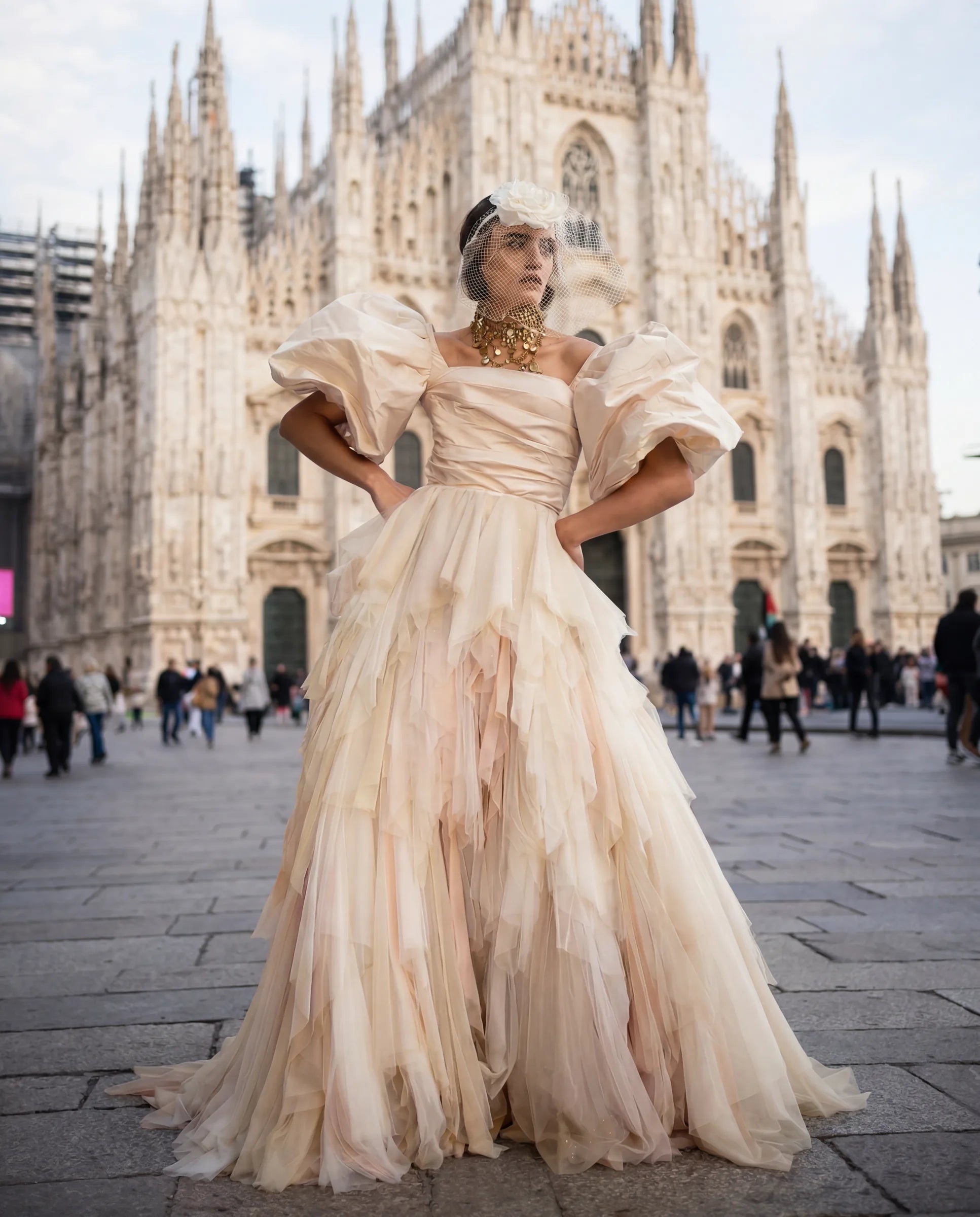 An ivory tulle gown photographed in the square before the Duomo, Milan.